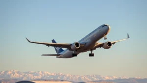 Modern commercial aircraft taking off from Denver International Airport with Rocky Mountains visible in distant background during golden hour lighting, clear blue sky, professional aviation photography