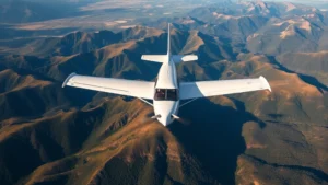 Aerial overhead view of small Cessna aircraft flying over scenic landscape with mountains and valleys visible below, natural lighting, professional aviation photography