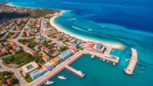 Aerial view of Willemstad, Curacao with colorful waterfront buildings and turquoise harbor water, tropical island landscape with boats and beaches visible