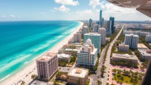 Overhead view of Miami skyline with turquoise ocean waters, Art Deco buildings in pastel colors, palm trees lining streets, sunny day, aerial photography from airplane window