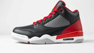 High-quality close-up of Jordan Flight Club '91 sneaker in classic black and red colorway, displayed on clean white background, showing detailed leather texture and Jumpman logo, professional product photography style